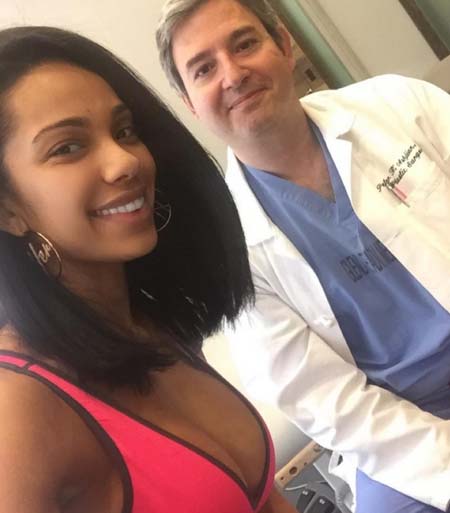 Erica with her doctor after getting her breast implants removed.